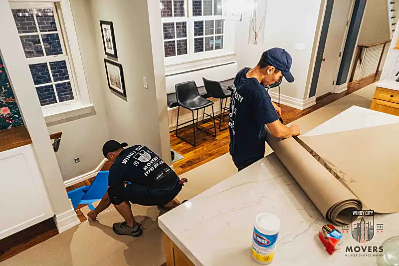 Windy City crew loading items at a building entrance